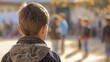 © ECLIVN - A young boy wearing a denim jacket stands in a crowded outdoor setting, looking thoughtfully at the people around him.