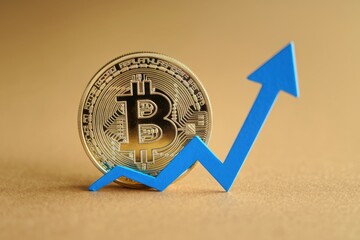 Aufkleber - A golden Bitcoin coin with a blue arrow pointing upwards  symbolizing its growth and value.