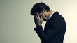 © Itsmagic - Man in suit expressing deep contemplation and stress