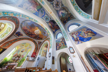 SOLY, BELARUS - SEPTEMBER 14, 2024: interior of old catholic church with columns and frescoes