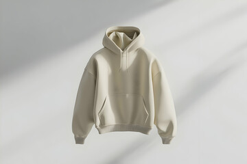 A minimalist beige hoodie displayed against a soft, light background.