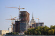 © Darya - Construction site. Tower cranes in action. Formwork and concrete pouring.