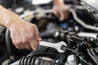 © zphoto83 - A mechanic using a wrench to repair an engine in an automobile workshop during daytime