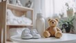 © Vlad - Maternity Leave Concept. Baby Shoes and Toy Bear on White Table in Room Background