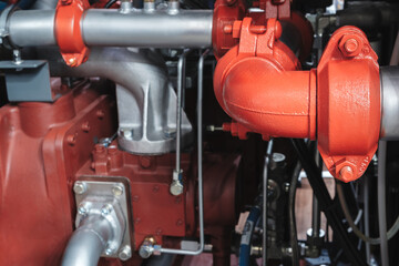 Aufkleber - A red pipe with a silver cap is attached to a red pipe. The pipes are connected to a industrial machine