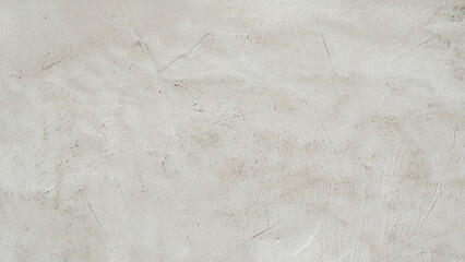 Aufkleber - A white wall background with a few small cracks. The wall is very plain and has no decoration. The cracks give the wall a somewhat aged and worn appearance