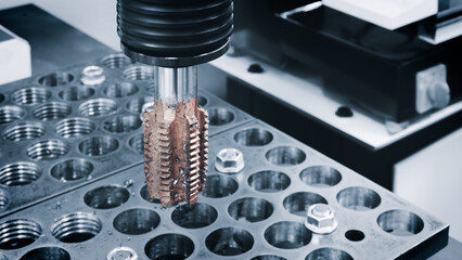 Poster - Part of a milling machine used to cut a piece of metal. The machine is surrounded by a number of small metal parts that it cuts. The concept of industrial precision and efficiency