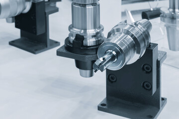 Poster - A machine with a tool on it. The tool is on a stand. The stand is black
