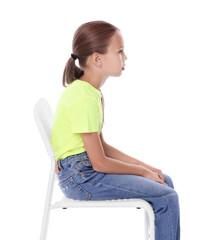 Wall Mural - Girl with incorrect posture sitting on chair against white background