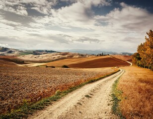 autumn italian rural landscape in retro style panorama of autumn field with dirt road and cloudy sky