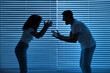 © New Africa - Emotional couple arguing indoors at night. Relationship problems