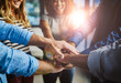 © peopleimages.com - Hands, group and stack at office with support, solidarity or goals with diversity at media company. Business people, teamwork and circle with synergy, link and happy for motivation at creative agency