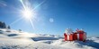 © BokehBox - Two Red Gift Boxes Wrapped with White Ribbons and a White Star Sit on a Snowy Landscape with a Bright Blue Sky and Sun Shining Above