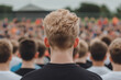 © Hew Pallot - back view of young man in crowd at outdoor event selective focus photography