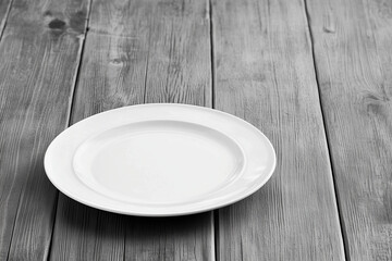 empty white ceramic plate on rustic wooden table surface black and white