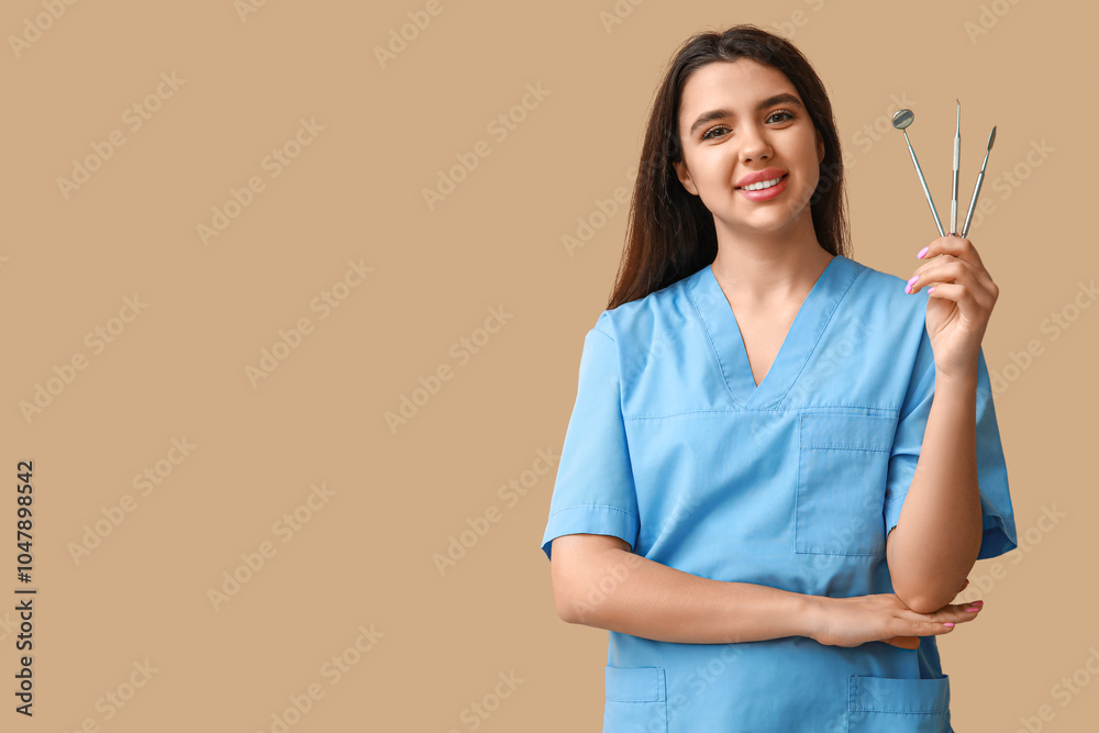Female dentist with tools on brown background. World Dentist Day