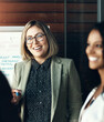 © peopleimages.com - Woman, group and employees brainstorming, meeting and collaboration with a new project, development and profit growth. Female leader, coworkers or consultant with clients, share ideas and partnership