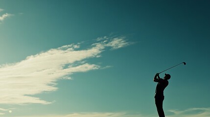 Wall Mural - A golfer swings against a clear sky, capturing the action and elegance of the sport.