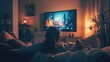 © Serge - A peaceful evening at home, with a person lounging on a couch, watching a movie on a large TV
