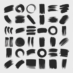 Poster - A collection of varied black brush strokes and circular shapes arranged on a light gray background surface
