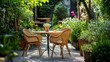 © Arifin Studio - A small patio table with wicker chairs and a potted plant sits in a lush garden with gravel pathways.