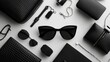 © Natchooda - Black and white accessories in flat lay format, with sunglasses, bag, and jewelry arranged for an organized, monochrome look.