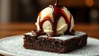 © Ole Studio - A decadent chocolate brownie topped with a scoop of vanilla ice cream and a generous drizzle of rich chocolate sauce, dusted with powdered sugar, a symphony of textures and flavors.