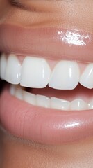 A close-up image showcasing a radiant smile with glossy lips and perfectly white teeth, highlighting dental and beauty care.