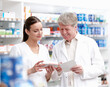 © peopleimages.com - Employees, pharmacists and reading prescription for medication, pills and information at drugstore box. People, pharmacy and happy with checklist for product, medicine and treatment for healthcare