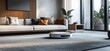 © VINA - White robotic vacuum cleaner on a grey carpet in a modern living room with a white sofa and a wooden wall.