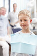 © peopleimages.com - Portrait, child and checkup with dentist at clinic for appointment, teeth whitening and dental hygiene. Happy, staff and patient with mouth cleaning, braces treatment and medical advice of childhood