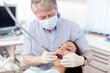 © peopleimages.com - Dentist, cleaning and woman with teeth care, medical check and patient consultation with oral exam. Wellness, consulting and hospital for dental hygiene, assessment and clinic tools in mouth