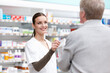 © peopleimages.com - Pharmacist, customer and support for medicine, care or wellness in drugstore, chemist or pharmacy. Medical professional, female person and man for prescription or info in dispensary as advice or help