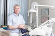 © peopleimages.com - Man, dentist and portrait in office for healthcare, business and friendly welcome. Mature orthodontist, equipment and smile in private practice with pride for knowledge in oral hygiene in Canada