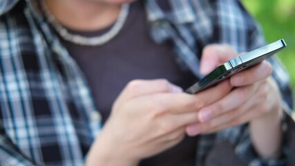 Young woman using smartphone outdoor. Caucasian girl looking at mobile phone. Communication, work or study, connection, mobile apps, technology, lifestyle concept. 