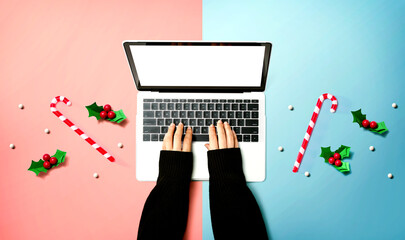 Wall Mural - Person using a laptop computer with Christmas decorations from above