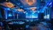 © Ubix - A spacious event hall illuminated by blue lighting, set with numerous round tables facing a large presentation screen.