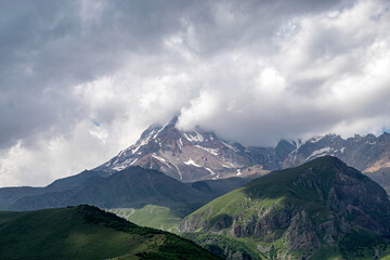 Wall Mural - beautiful mountain landscape, clouds cover mountain peaks, Kazbek, Georgia