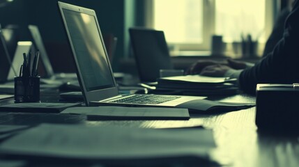 Fototapete - Close-up of a Laptop on a Desk with Papers and a Pen Holder