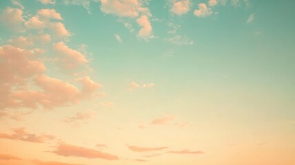 Wall Mural - A pastel sky with delicate layers of light blue and soft peach clouds glowing in the fading light of a tranquil evening