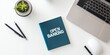 © Nijat - A notebook says 'OPEN BANKING' next to a laptop and mouse on a white desk.
