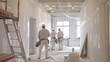 © Justlight - A team of painters carefully priming the walls of a newly renovated office space.