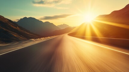 Poster - A road with mountains in the background and a sun shining on it
