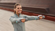© Valerii Apetroaiei - A Young Woman Actively Exercising with Weights, Specifically Dumbbells, Outdoors in Nature