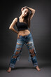 © Mountains Hunter - A beautiful brunette poses in the studio wearing a top and jeans.