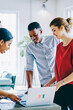 © BullRun - Multiethnic young people in casual wear working together with documents and laptop