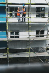Aufkleber - Blueprint, man and woman on construction scaffolding with planning, collaboration and urban architecture. Ideas, discussion and contractor team on site for civil engineering, building and development