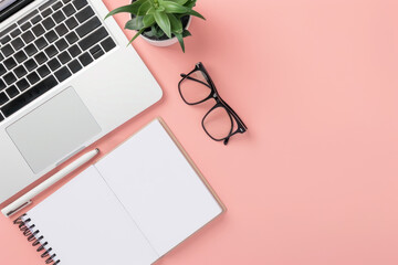 A minimalist workspace with a laptop, glasses, and a notepad on a pink background. The clean, organized setup offers ample space for text, ideal for business or educational themes