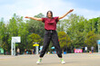 © M Alfan Setyawan - happy asian woman jumping in mid air workout in outdoor basketball court
