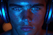 © sandipruel - A man illuminated by blue light in headphones. The image conveys a mood of relaxation and enjoyment.